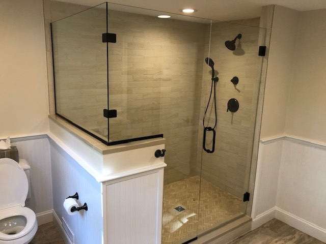 Navy double vanity with dual arched mirrors and brushed nickel vanity lights